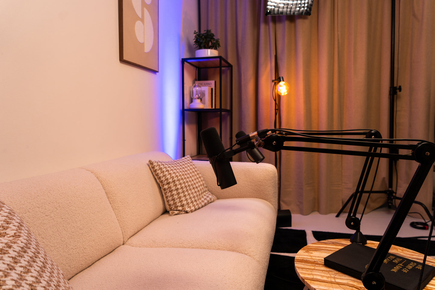 A close up of the micraphones and the couch in the studio