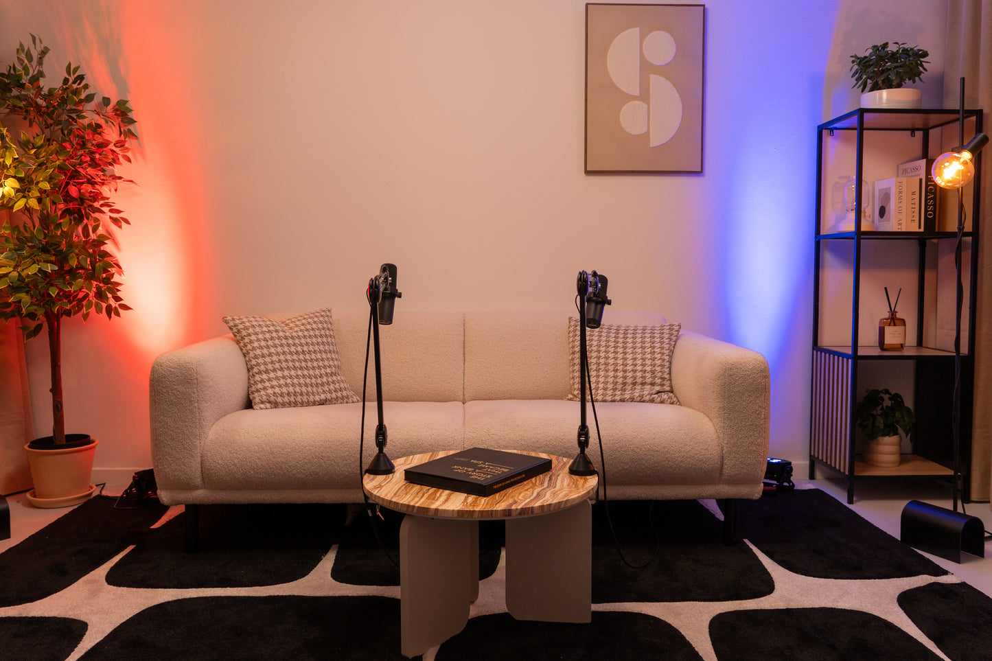 Podcast studio with a couch set-up and micraphones