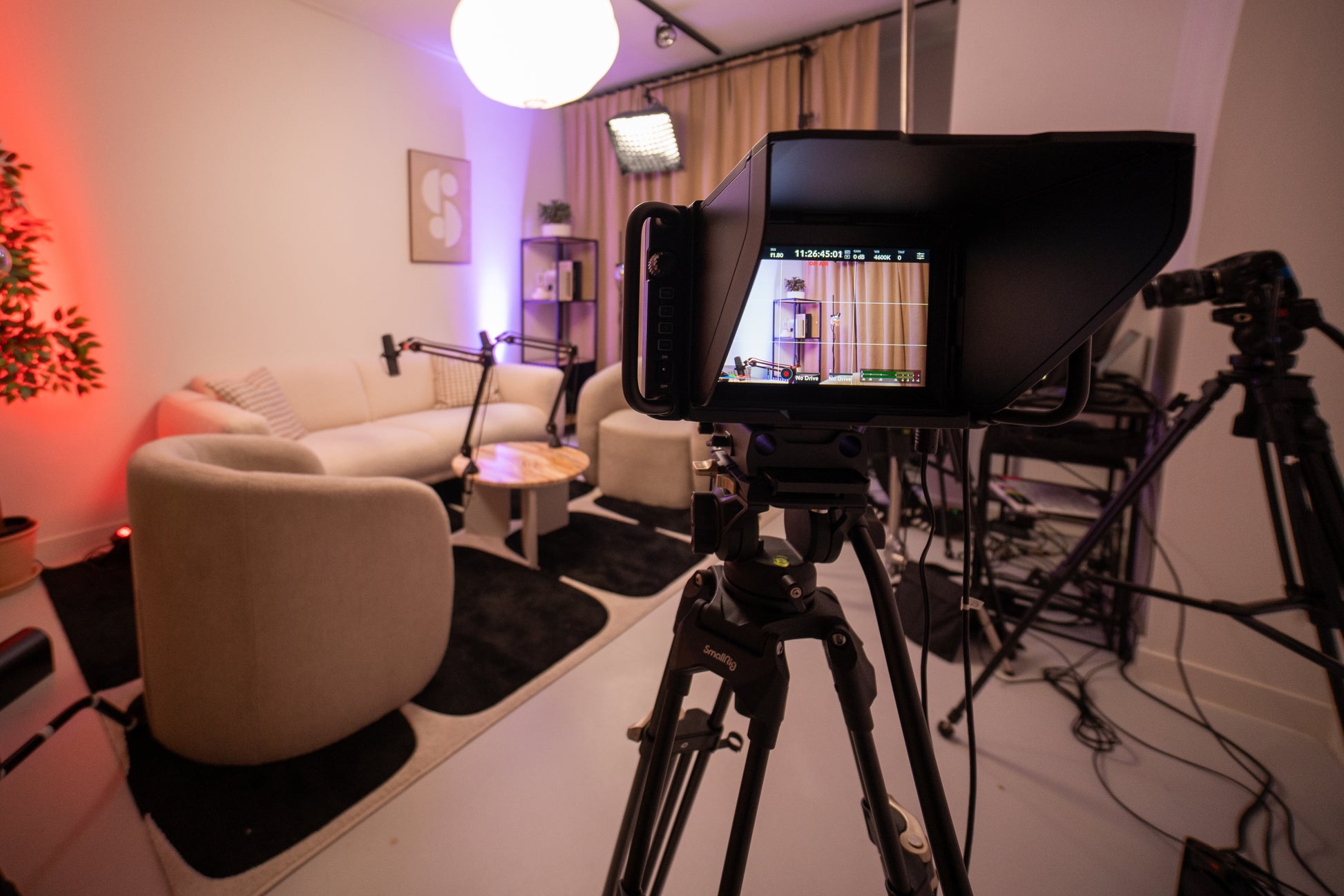 Amsterdam odcast studio with a set-up, micraphones, cameras and lights through a camera lense